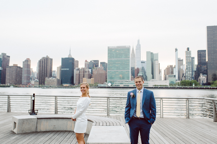 Colleen and Patrick had an intimate wedding ceremony at their church in Queens, NY then we went over to Gantry Plaza State Park LIC for their wedding photos. Colleen and Patrick's NYC elopement was nothing but fabulous and spectacle. When I saw all the food trucks lined up along Gantry Plaza State Park I knew I wanted to use it as our backdrop for Colleen and Patrick. Of course we chose "Mr Softee's Ice Truck" and as we were taking the photo one of Colleen and Patrick's cousin walked by doing the most epic photobomb ever! Colleen and Patrick's NYC elopement Gantry Plaza State Park LIC captured by NY NJ Weddings, Elopements and Family Photographer Karis by Hey Karis.